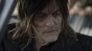 Close-up of Daryl's face inside a vehicle in The Walking Dead: Daryl Dixon - The Book of Carol