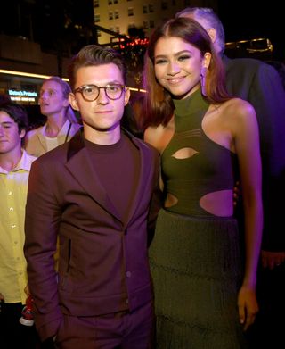 Tom Holland and Zendaya pose next to one another on a red carpet