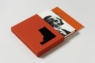 A copy of the book with red slipcase photographed against a grey background