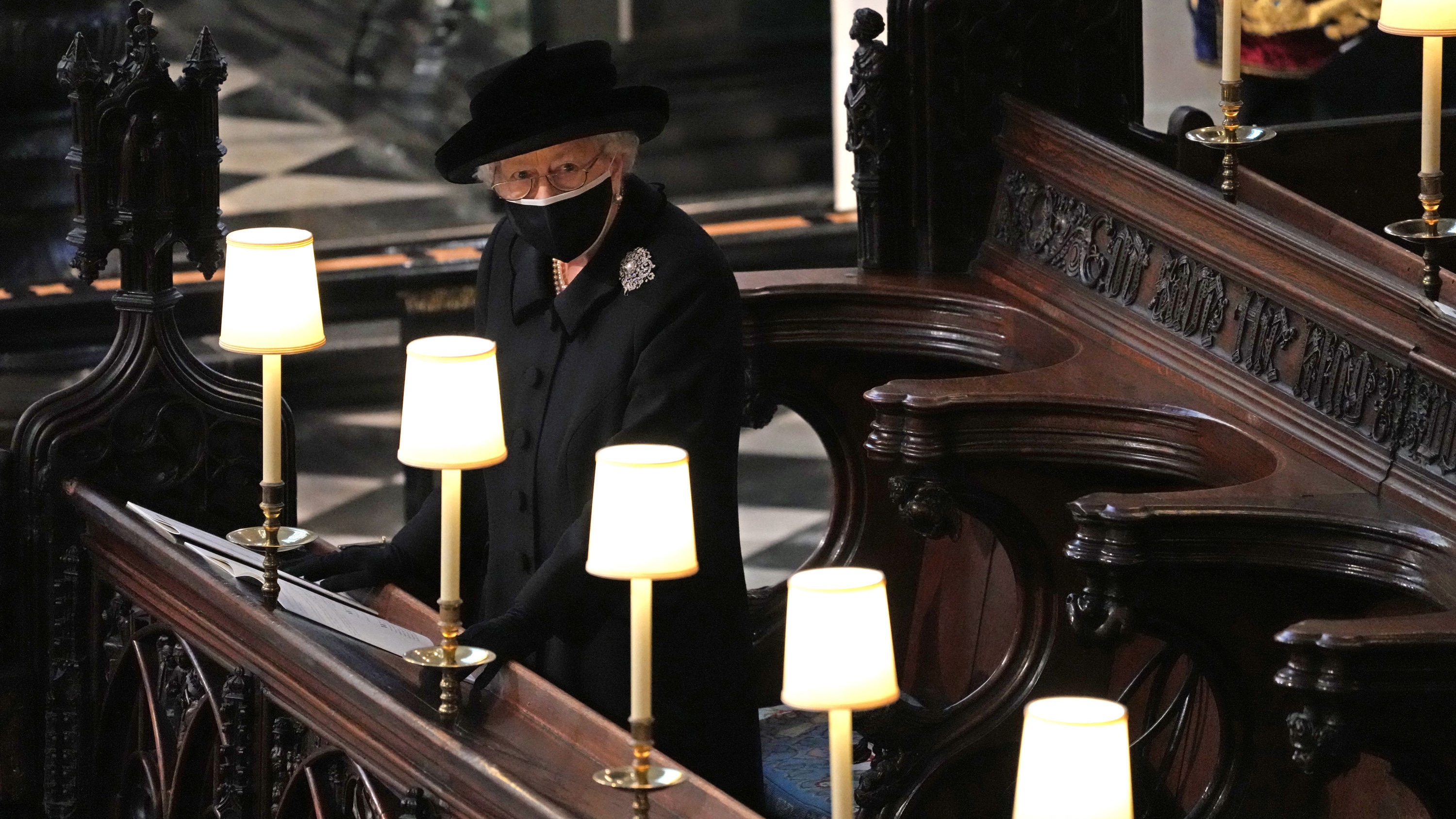 Queen Elizabeth II watches as pallbearers carry the coffin of Prince Philip, Duke Of Edinburgh into St George&amp;rsquo;s Chapel during his funeral at Windsor Castle on April 17, 2021