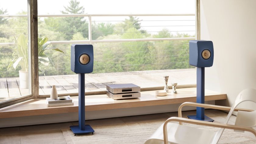 KEF LS50 Meta in royal blue on stands in a living room setting