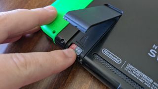 MicroSD card being inserted in Nintendo Switch