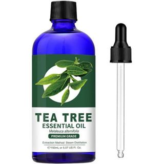 A blue glass bottle of Tea Tree essential oil with black cap, white and green label and pipette