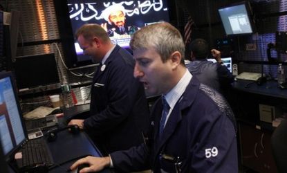 News of Osama bin Laden's death flashes on the screen behind New York Stock Exchange traders: The al Qaeda leader's death could ease tensions in the oil-rich Middle East, say some commentator