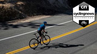 Cyclist riding one of the best endurance road bikes up an empty road