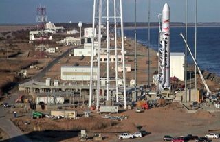 Aerial view of Wallops Island launch site that includes artist concept of Antares rocket on pad.