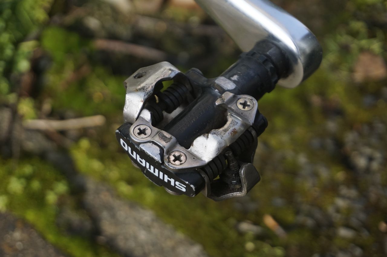 A close up of a silver gravel bike pedal