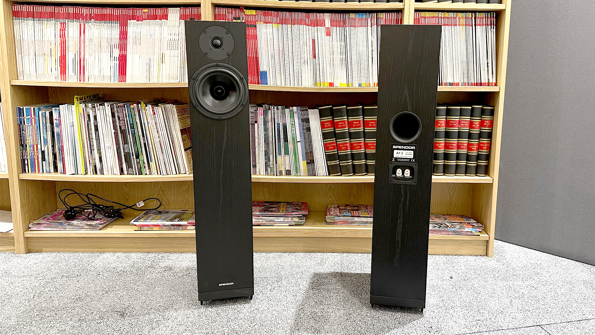 Spendor A7.2 floorstanding speakers on grey carpet in front of bookcase