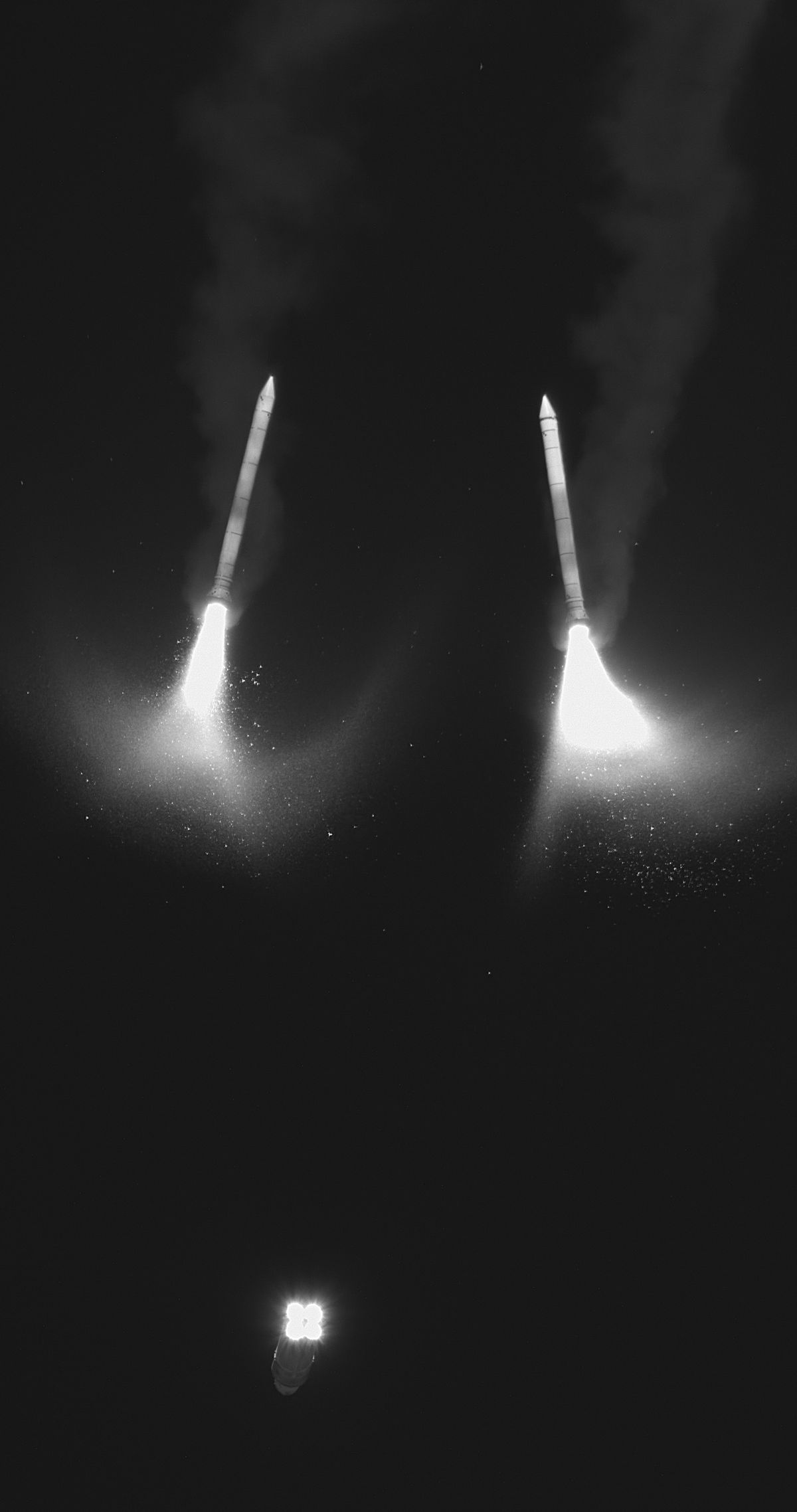 In this black and white infrared image, two solid rocket boosters from NASA&rsquo;s SLS (Space Launch System) rocket separate from the core stage and Orion spacecraft