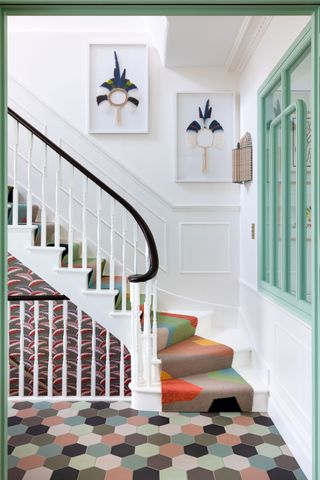 Multicoloured hexagon tiled flooring and multicoloured stairway carpet