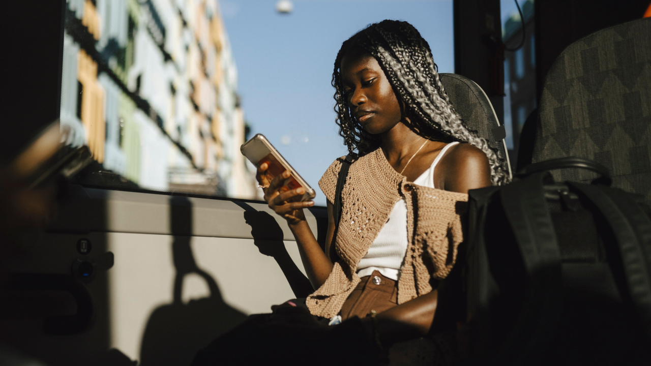 A woman on her phone wondering what to do about her ex texting her