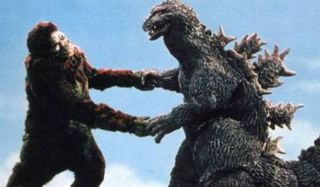 King Kong vs Godzilla battling in front of the sky