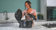 Woman using our pick of the best slow cooker - the Ninja Foodi Mini 6-in-1 Multi-Cooker OP100UK