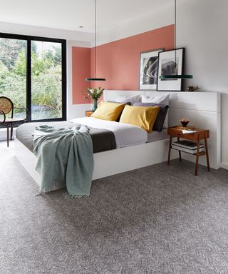 Bedroom carpet ideas with grey herringbone carpet on the floor of modern bedroom with orange walls
