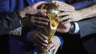Many hands on the FIFA World Cup trophy