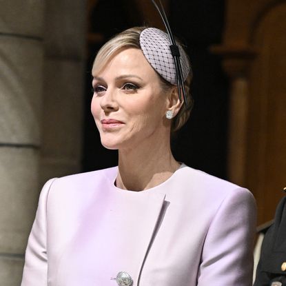 Princess Charlene wears a lilac pantsuit and her engagement ring from Prince Albert