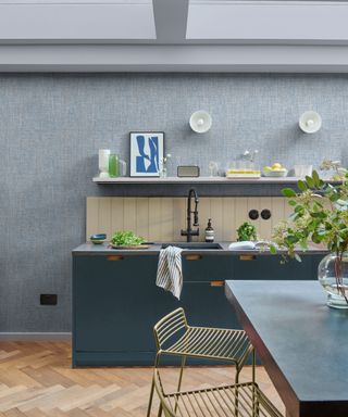 kitchen with blue textured wallpaper, blue kitchen units and kitchen island