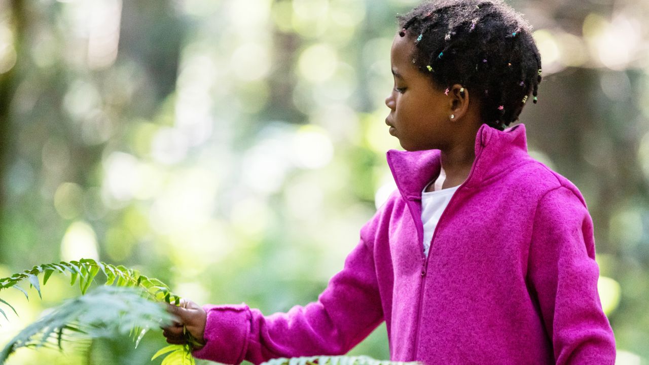 child in fleece exploring nature