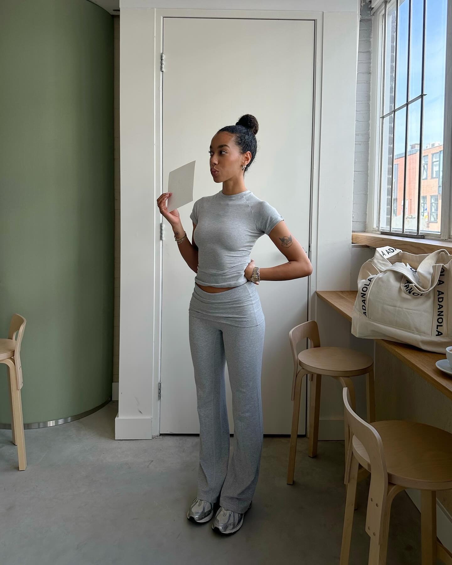 Fashion person Amaka Hamelijnck wears a winter legging trend 2025. She wears grey bootcut legging with a matching grey top. This image was taken recently from her Instagram.
