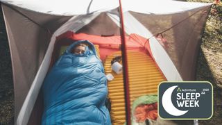 Young woman sleeping in a sleeping bag in tent
