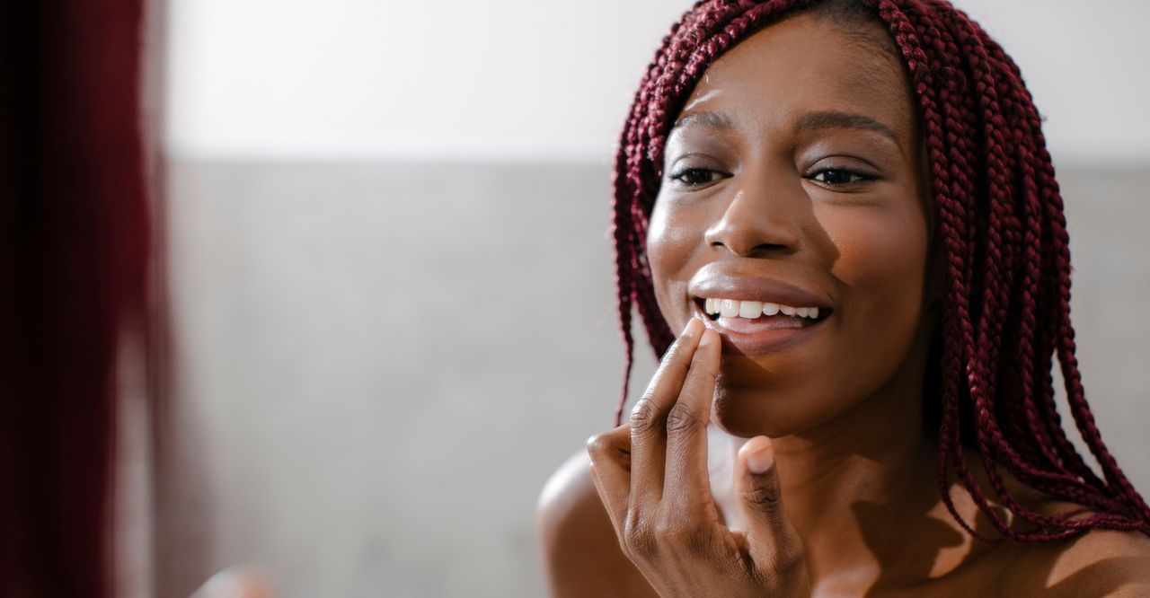 Woman applying lip balm