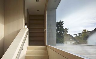 Kahlstrasse House interiors with large glass window on staircase