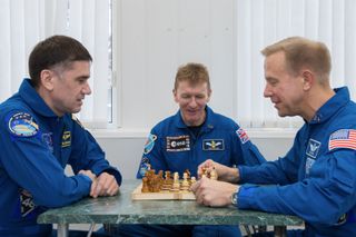 The three Expedition 46-47 crewmembers — Yuri Malenchenko, Tim Peake and Tim Kopra (left to right) — play chess during training. Only three men alive know who won this match… and they're not telling, because they've got more important things to do. They're in space.