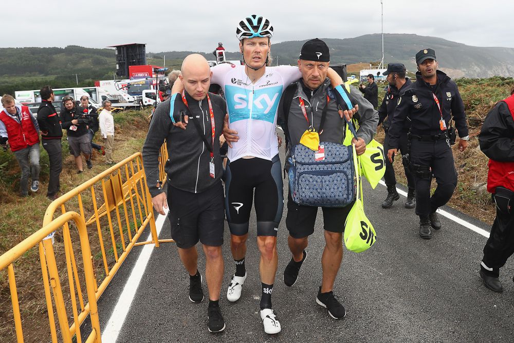 Dylan van Baarle is helped away from a crash after stage 12 at the Vuelta