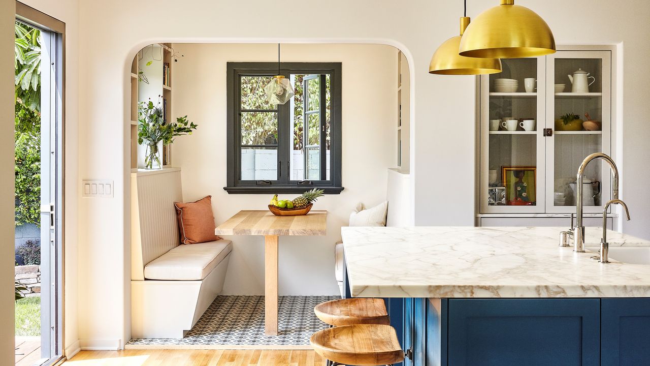 A small kitchen with seating nook