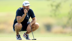 Dustin Johnson lines up a putt