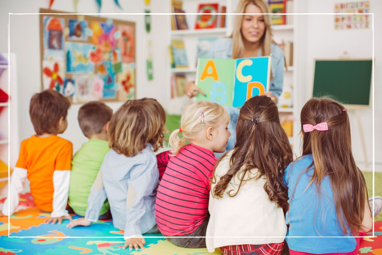 children sitting on the floor in front of caregiver at nursery