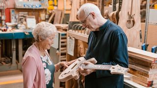 Ted McCarty’s daughter Sue Davis and Paul Reed Smith look at a guitar in the PRS factory