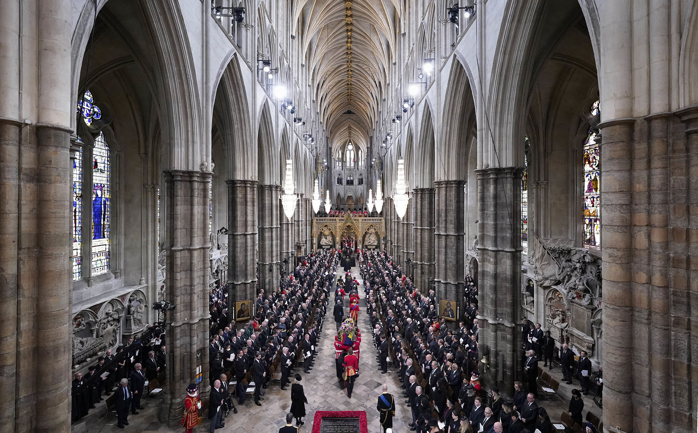 A Bearer Party of The Queen&#039;s Company, 1st Battalion Grenadier Guards carries the coffin of Queen Elizabeth II, draped in the Royal Standard, from the State Gun Carriage of the Royal Navy at Westminster Abbey in London on September 19, 2022, during of the State Funeral Service. (Photo by Danny Lawson / POOL / AFP)