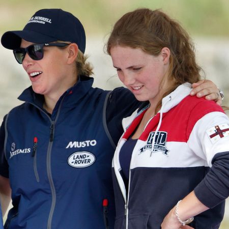 Zara Tindall wearing a blue jacket putting her arm around Stephanie Phillips