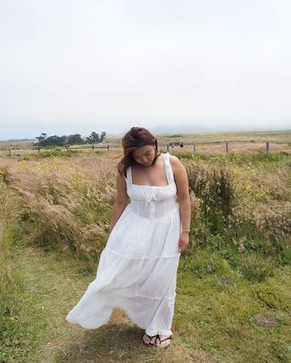 @marina_torres wearing a white dress with black shoes