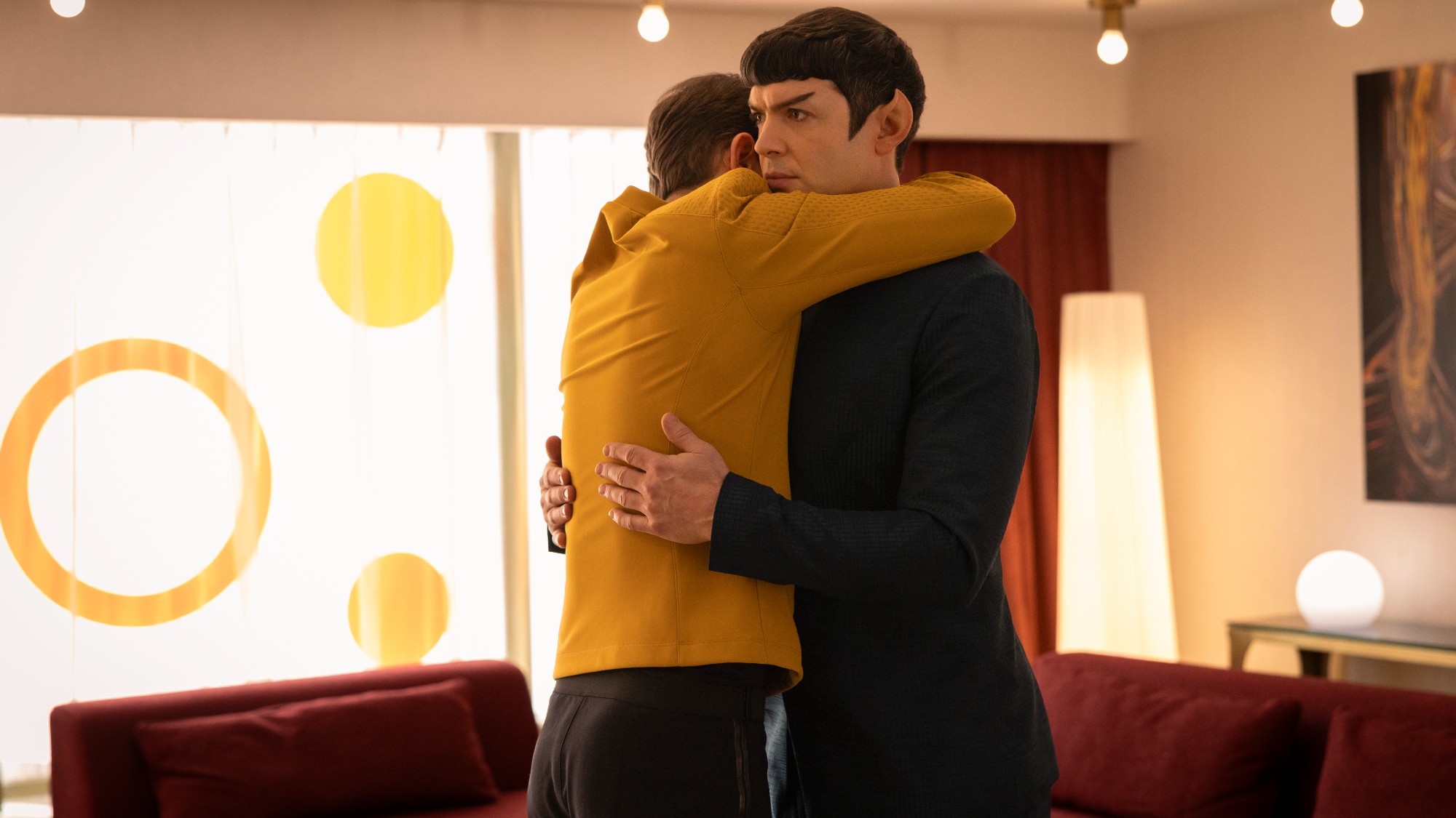 Kirk embracing Spock in a big hug.
