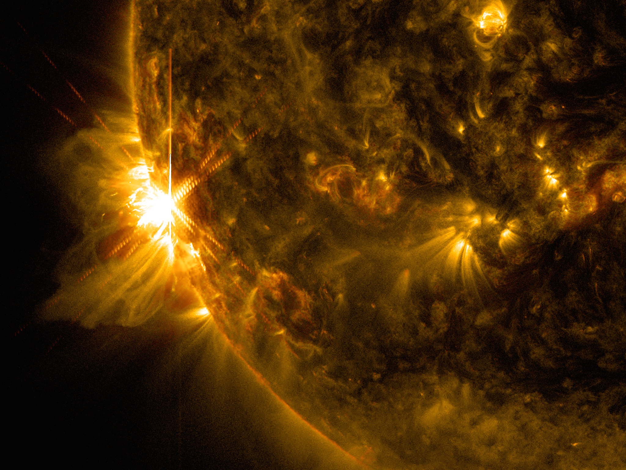 A massive X2.2 solar flare erupts off the left limb of the sun in this view captured by NASA&#039;s Solar Dynamics Observatory on June 10, 2014, at 7:41 a.m. EDT.