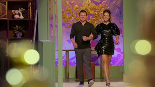 hosts Nick and Vanessa Lachey enter the Love is Blind soundstage, in season 7.