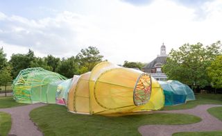 The structure is covered in panels of translucent, multi-coloured fluorine-based polymer (ETFE).