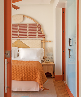 Bright bedroom with orange, red and blue tones