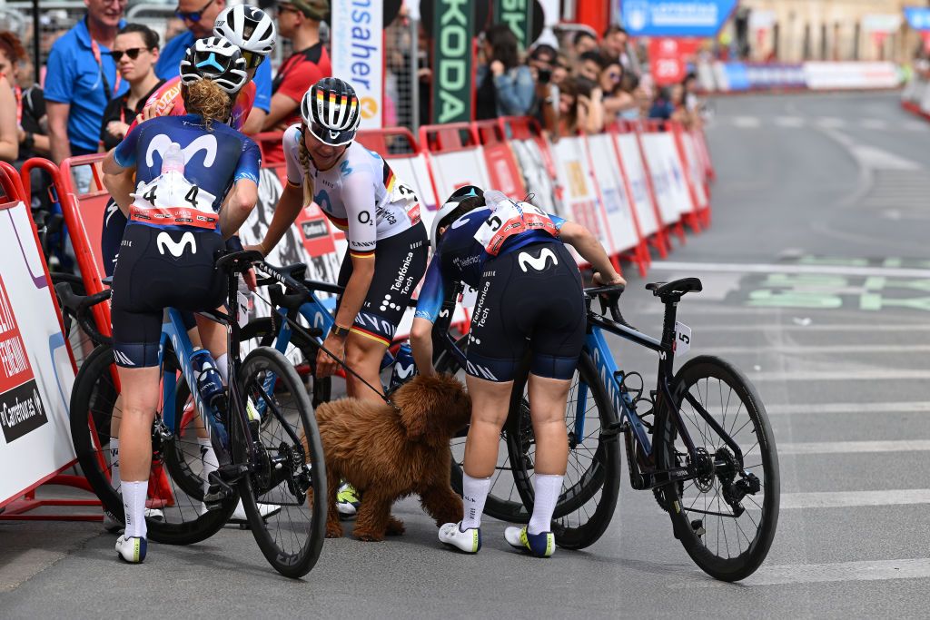 LA RODA SPAIN MAY 03 LR Floortje Mackaij of The Netherlands with her dog Liane Lippert of Germany and Lourdes Oyarbide of Spain and Movistar Team after the 9th La Vuelta Femenina 2023 Stage 3 a 1578km stage from Elche de la Sierra to La Roda UCIWWT on May 03 2023 in La Roda Spain Photo by Dario BelingheriGetty Images