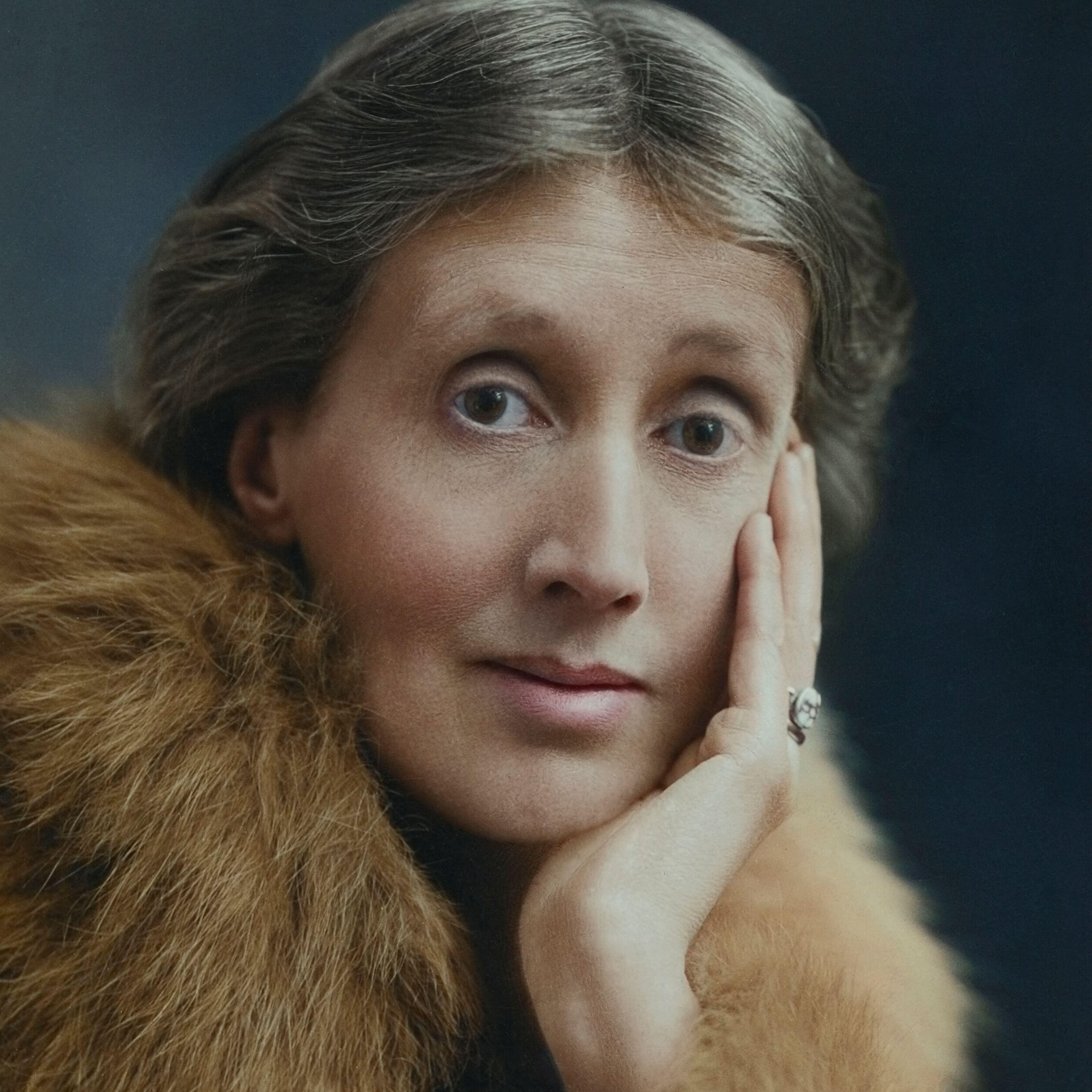 Virginia Woolf resting her head in her hand, wearing a fur stole