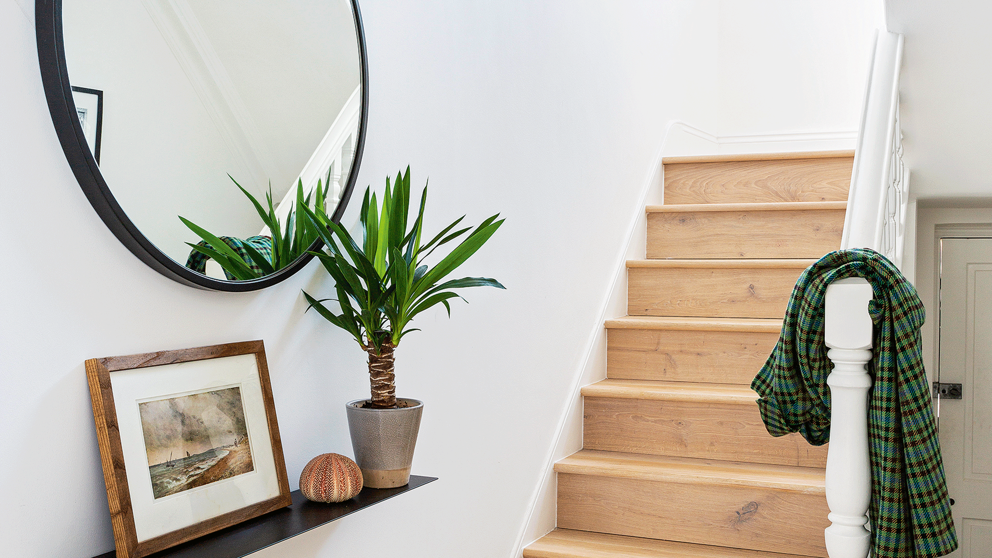 White hallway with wall of elevated storage