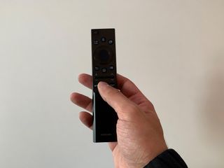 Stephan's right hand holding the Samsung Smart Remote