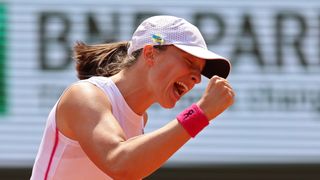 Iga Swiatek of Poland celebrates winning match point ahead of the women's French Open Final at Roland Garros.