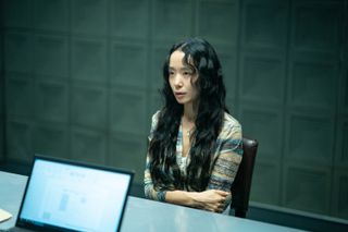 A woman (Jeon Do-yeon) sits in an interrogation room, in 'The Price of Confession.'