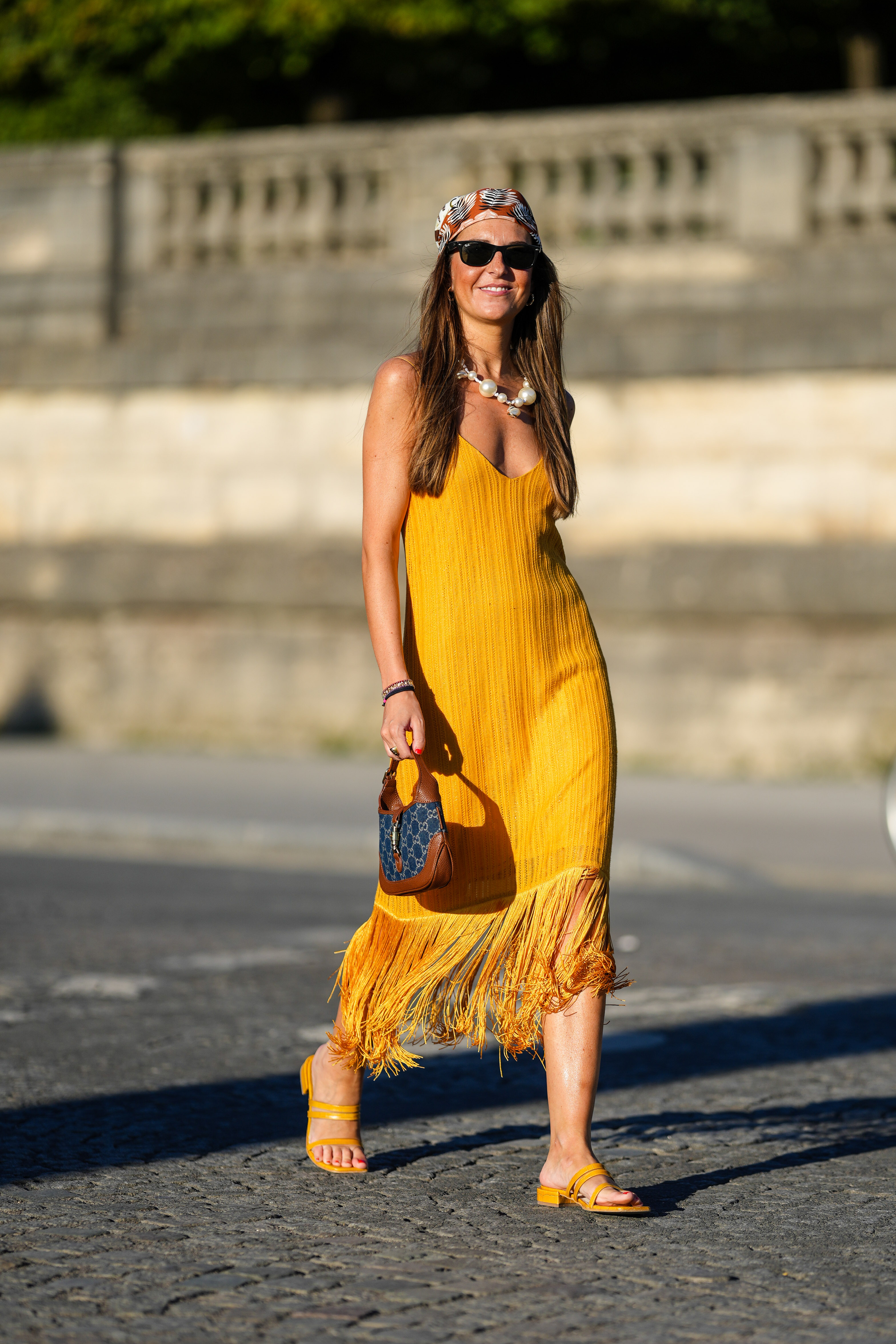 woman wearing a yellow fringed dress