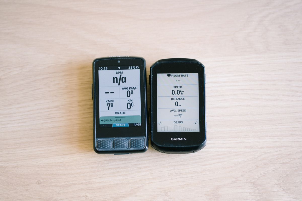 Bike computers on a table top showing different data screens
