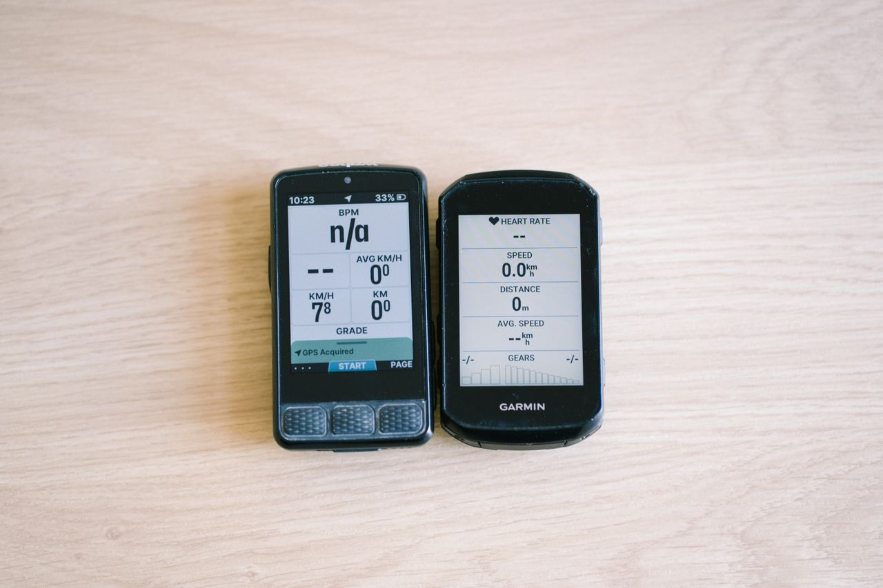 Bike computers on a table top showing different data screens