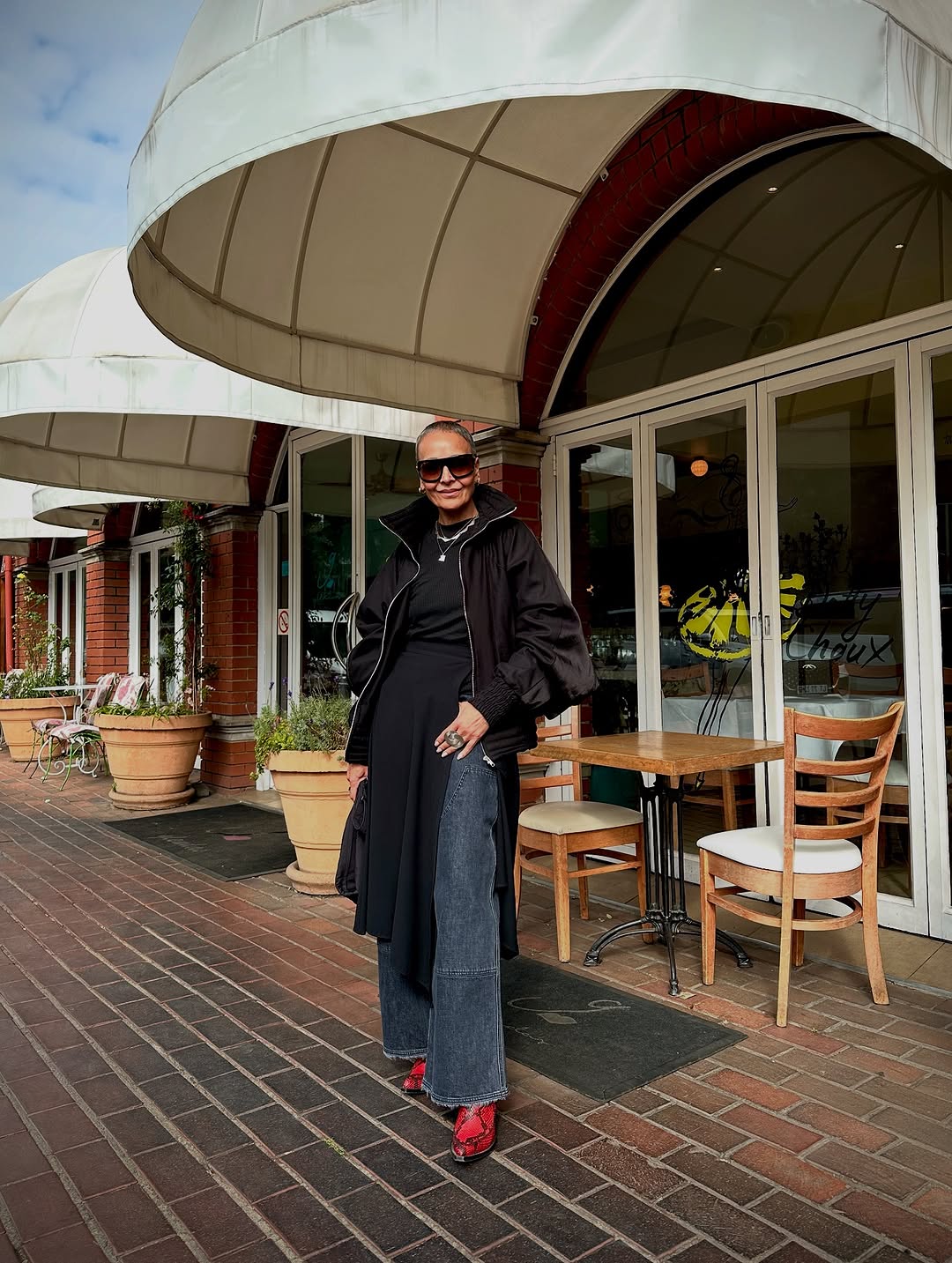 woman wearing dress over pants fall outfit 2025